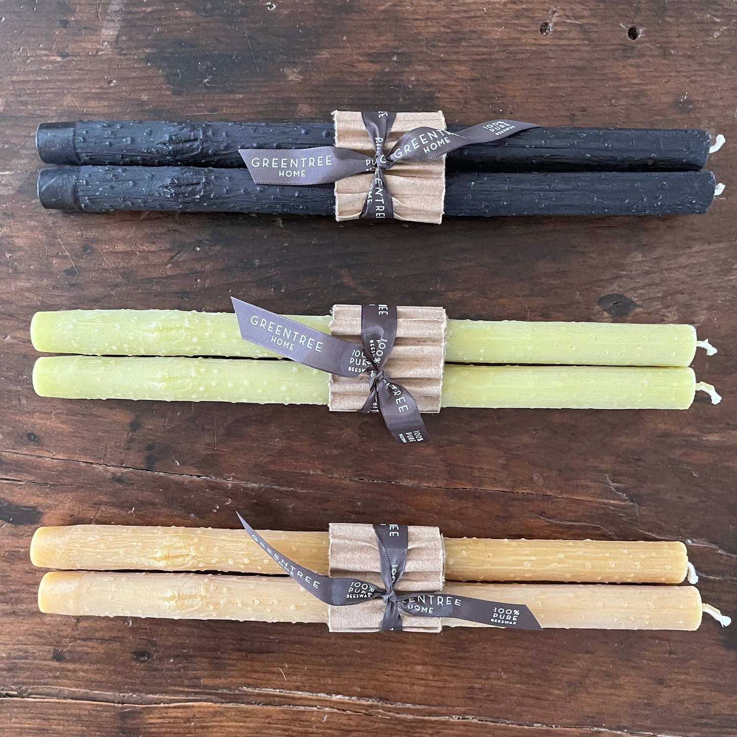 Taper twig candles  cast from beeswax in black, bamboo green, and natural colors.