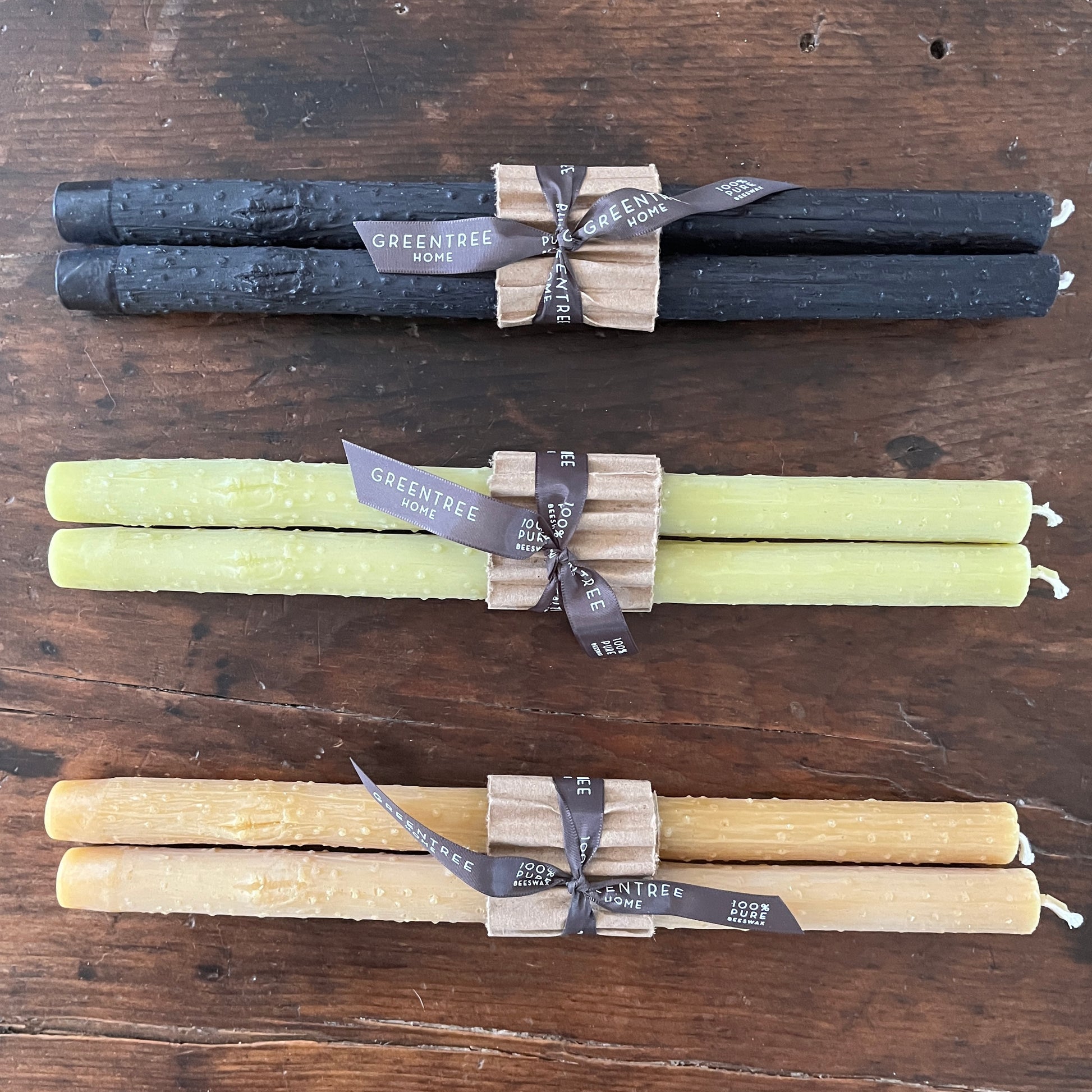 Taper twig candles  cast from beeswax in black, bamboo green, and natural colors.