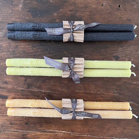 Taper twig candles  cast from beeswax in black, bamboo green, and natural colors.